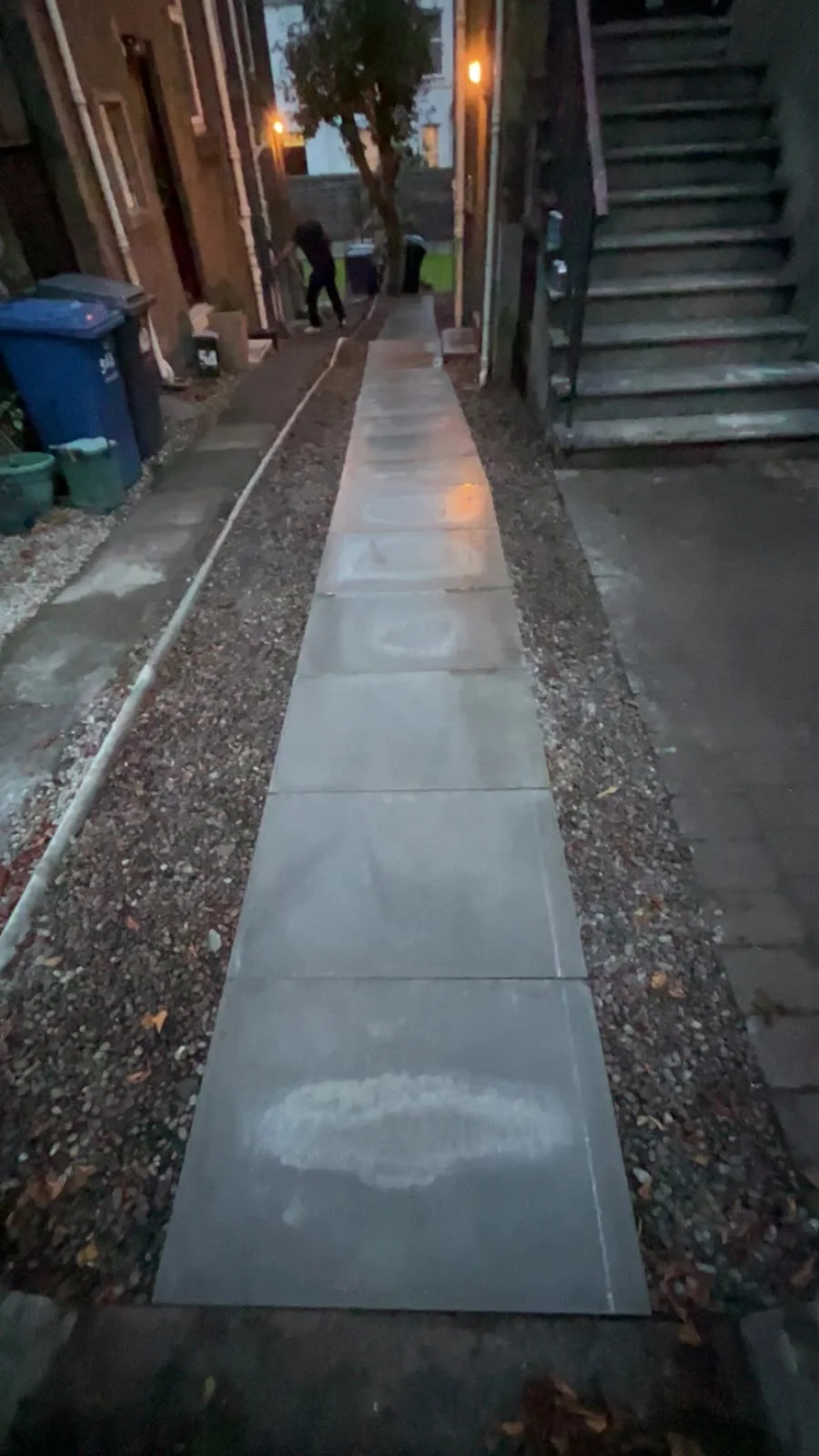 Slab pathway running along a Greenock side return.