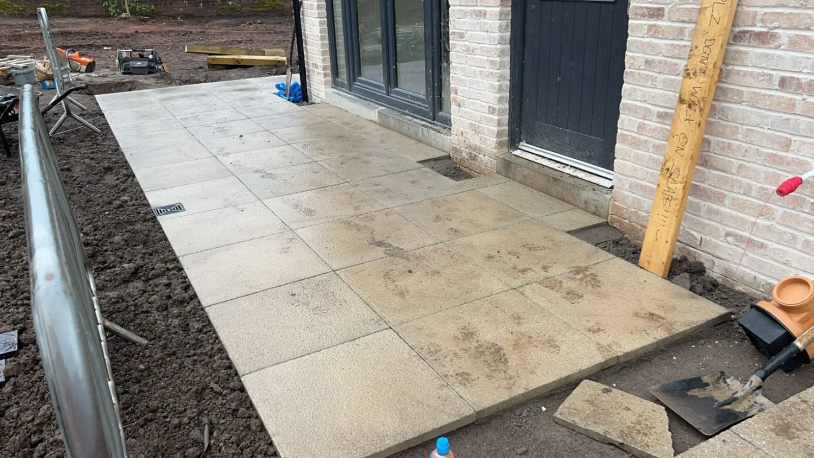 Porcelain slabs laid at the back door of a new-build home in Greenock, with a channel drain set into the paving.
