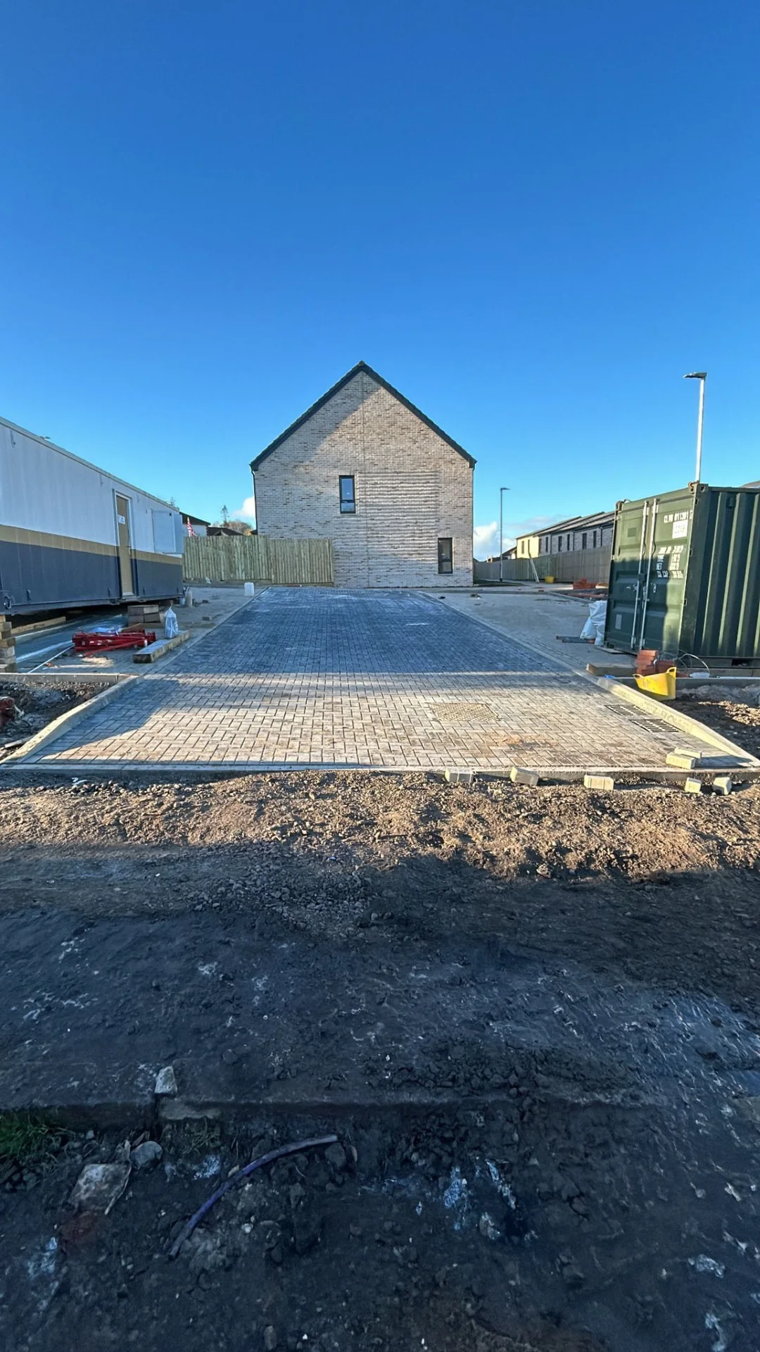 Monoblock car park taking shape at the Greenock luxury townhouse development, with the parking bays laid in front of a new-build home.