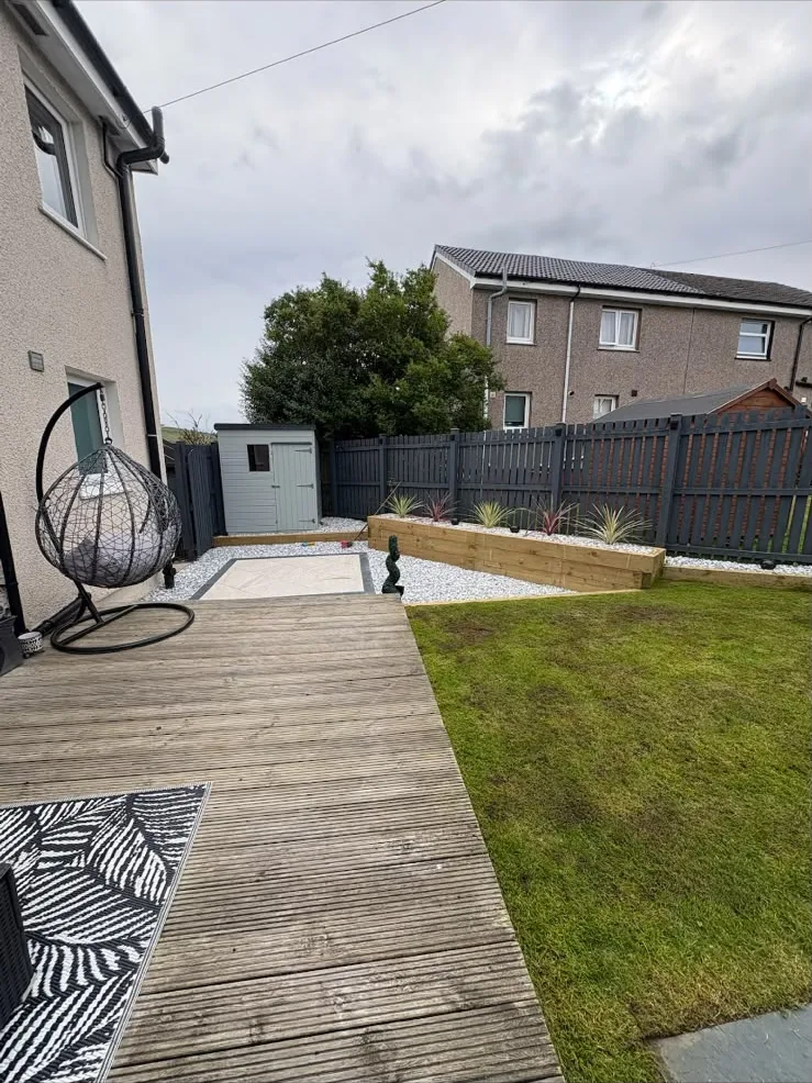 Porcelain tiles, chips and sleeper flower beds beside the lawn, Ayr.