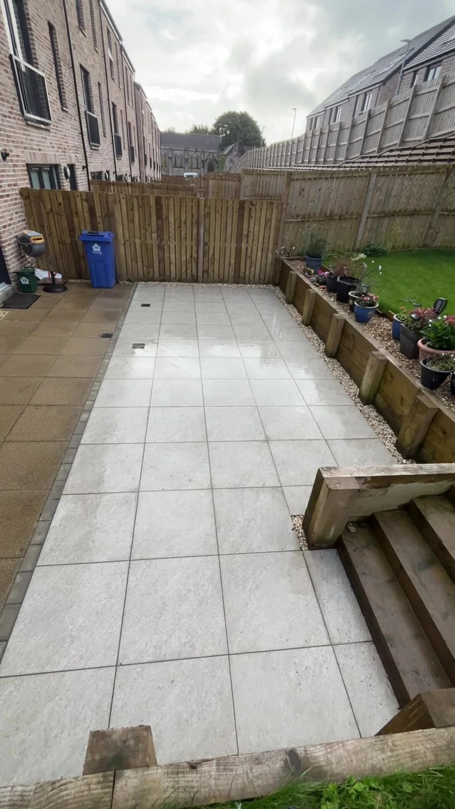 Greenock townhouse patio with raised sleeper beds and timber fencing.