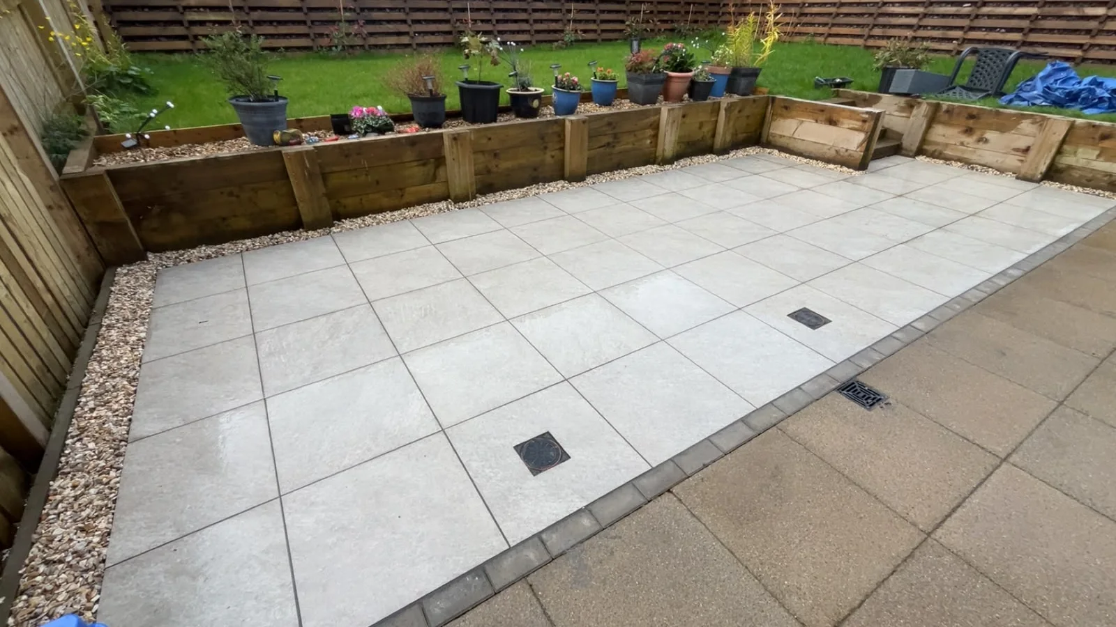 Patio paving with drainage covers in a Greenock townhouse garden.