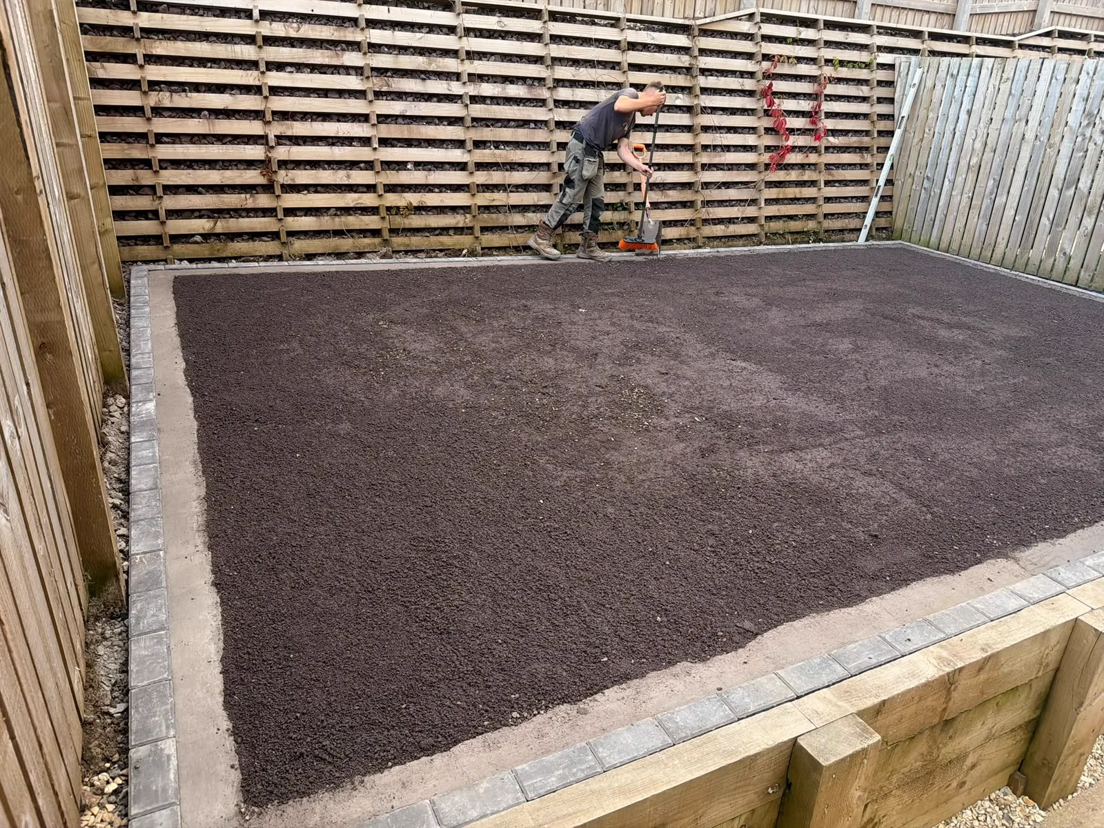 Sleeper retaining wall with block edging built by Jackson's at the Greenock luxury townhouse development, with the ground prepared for the next stage — the timber fencing behind was not part of the job.